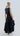 Back view of Psophía poplin dress with embroidery and layered ruffle skirt for elegant movement.