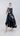 Psophía embroidered poplin dress with sequins and layered ruffle skirt, blending structure and fluid movement.