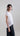 Side view of the cocoon tee, showing subtle volume, fluid drape, and flexible drawcord shaping at the hem.