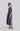Side view of the Retro Prism dress showing asymmetric side cuts and fluid movement of the wide silhouette.