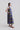 Opposite side view of the Retro Prism dress highlighting geometric print contrast and sculptural asymmetry