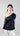 Front view of asymmetric mercerized cotton T-shirt featuring a one-shoulder silhouette and cascading rosette detail.