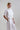 Side view of a short-sleeve cotton bolero showing its clean lines, structured shape and soft layering over tops.