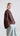 Side view of Psophía SS26 women’s cotton and tencel bomber jacket showcasing the Japanese sleeve, rounded hem, and side slits for fluid movement