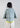 Back view of cropped double-breasted blazer in technical cotton blend, featuring a structured silhouette and clean tailored finish.