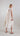 Back view of an embroidered Tencel dress highlighting the yoke and gathered fabric for fluid movement.
