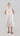 Front view of a flowing embroidered Tencel dress showing its airy volume, soft gathers and A-line silhouette.