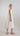 Side view of a flowing Tencel dress showing its wide A-line shape and integrated cape-style sleeves.