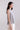 Side view of flared sleeveless mercerized cotton T-shirt highlighting soft movement and relaxed contemporary fit.