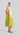 Flash Lemon sleeveless peplum dress shown from the side, highlighting flowing skirt and delicate embroidered details.