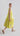 Flash Lemon sleeveless peplum dress shown from the opposite side, emphasizing peplum flare and lightweight fabric movement.