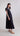 Side view of Psophía SS26 women’s poplin maxi dress highlighting the fluid movement of the skirt and the elegant volume of the puff sleeves.