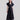Side view of Psophía SS26 women’s poplin maxi dress highlighting the fluid movement of the skirt and the elegant volume of the puff sleeves