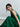 Psophía light jacquard sleeveless midi dress in green with babydoll silhouette and fluid feminine movement.