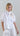 Front view of a lightweight sheer organza blouse with a classic shirt collar, wide short sleeves, floral appliqué details and an adjustable drawstring waist.