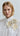 Lookbook image of a sheer organza blouse with floral appliqué, styled with high-waisted pieces for a contemporary spring–summer outfit with a serene and elegant aesthetic.