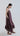 Side view of Psophía SS26 women’s Lunar Breeze slip dress highlighting the relaxed silhouette and the fluid movement of the volant hem.