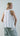 Back view of the muted peony sleeveless top highlighting fluid drape and relaxed silhouette.