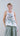 Front view of women’s sleeveless round-neck top with muted peony print and subtle side points.