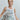 Women’s muted peony sleeveless round-neck top styled with relaxed oversized silhouette and subtle side points.