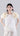 Front view of Psophía poplin short-sleeve top with round neckline and floral embellished sleeves.