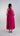 Back view of rayon silk halter maxi dress highlighting open shoulders and fluid asymmetric skirt