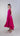 side view of rayon silk halter maxi dress showing fluid drape and asymmetric bell-shaped skirt.