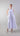 Front view of sleeveless mercerized cotton midi dress featuring a round neckline and sculptural rosette on the shoulder.