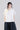 Alternate front view of wide mercerized cotton T-shirt highlighting the draped rosette detail and fluid contemporary silhouette.