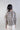 Back view of plaid Bardot blouse showing smooth hem, flowing sleeves and relaxed, minimalistic silhouette.