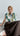 Lookbook image of a printed sleeveless cotton blouse with epaulettes styled in a relaxed boho and contemporary aesthetic.