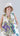 Lookbook image of a printed cotton sleeveless midi dress styled with a relaxed boho and contemporary aesthetic.