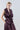 Front view of women’s sleeveless taffeta wrap top with notched lapels, patch pockets and integrated belt.