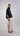 Side view of a fluid lightweight shirt, showcasing its relaxed drape, asymmetrical hem and softly structured silhouette with architectural appeal.